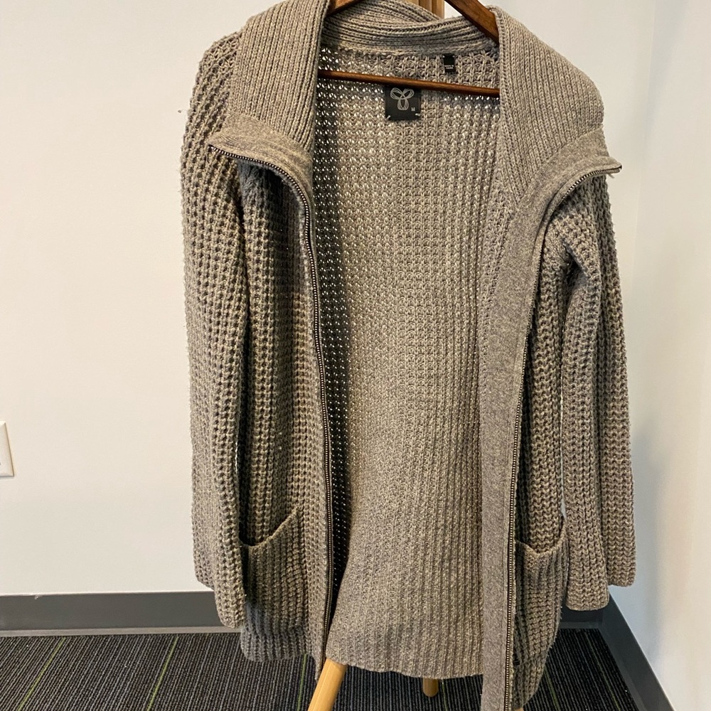 TNA long grey wool zip-up sweater with pockets.